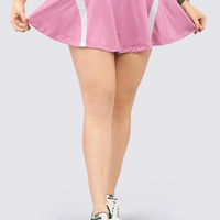 Falda deportiva color rosado, con short interno y pretina cruzada.