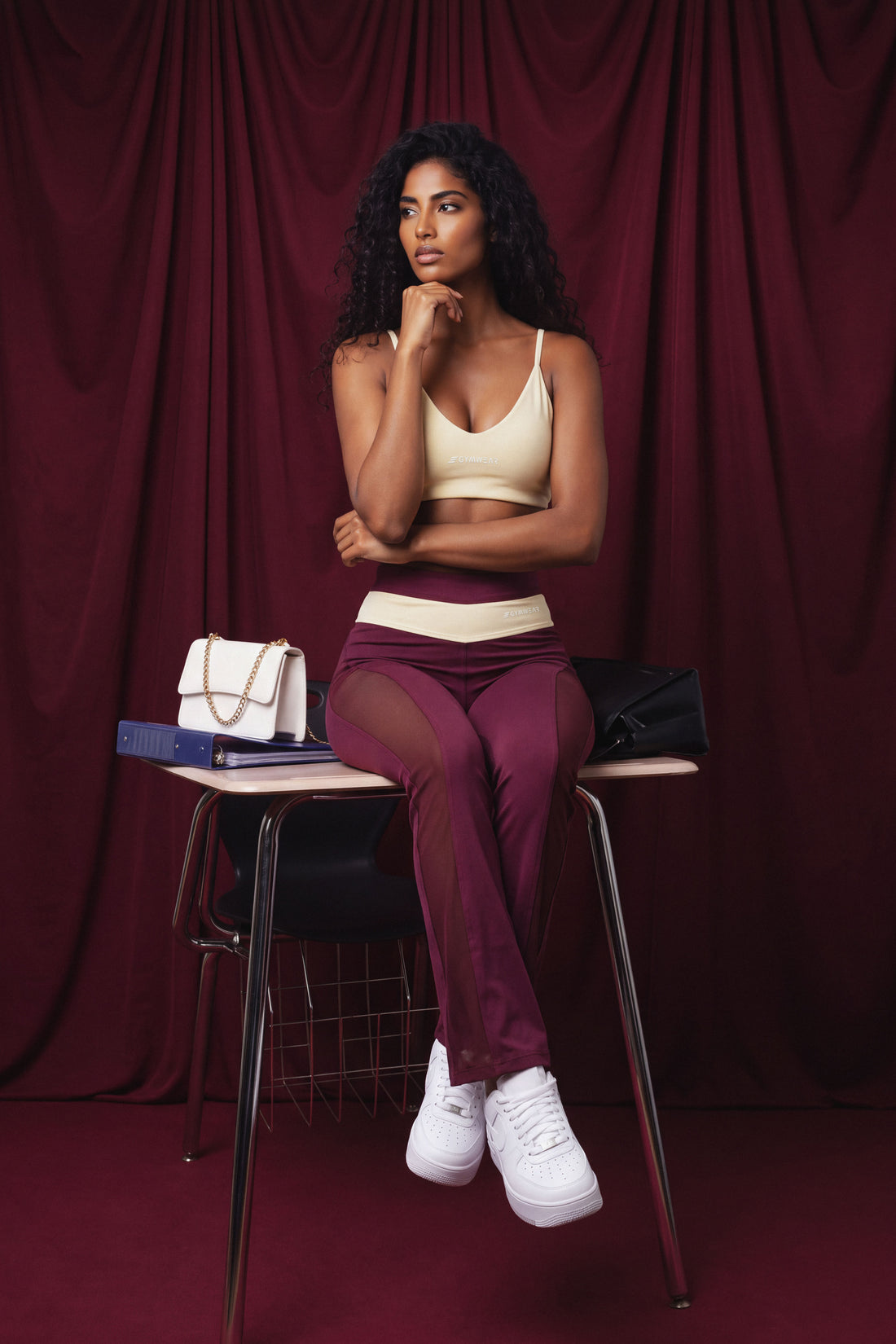 Leggings color merlot, con paneles de malla elástica a lo largo de las piernas, ajustado en la cintura y bota recta. 