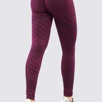 Leggings deportivo seamless vinotinto, de talle alto y patrones de líneas y circulos. 